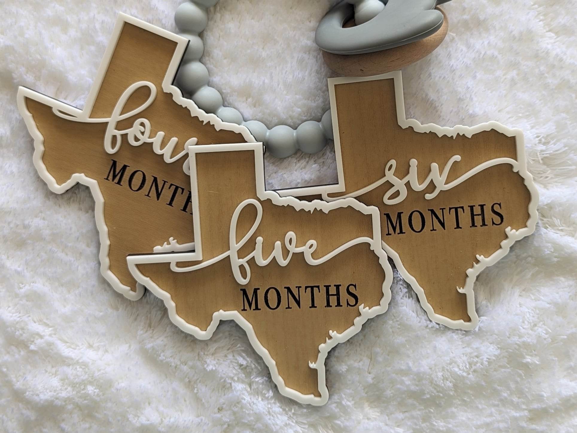 Texas shaped baby milestone props months four, five and six.