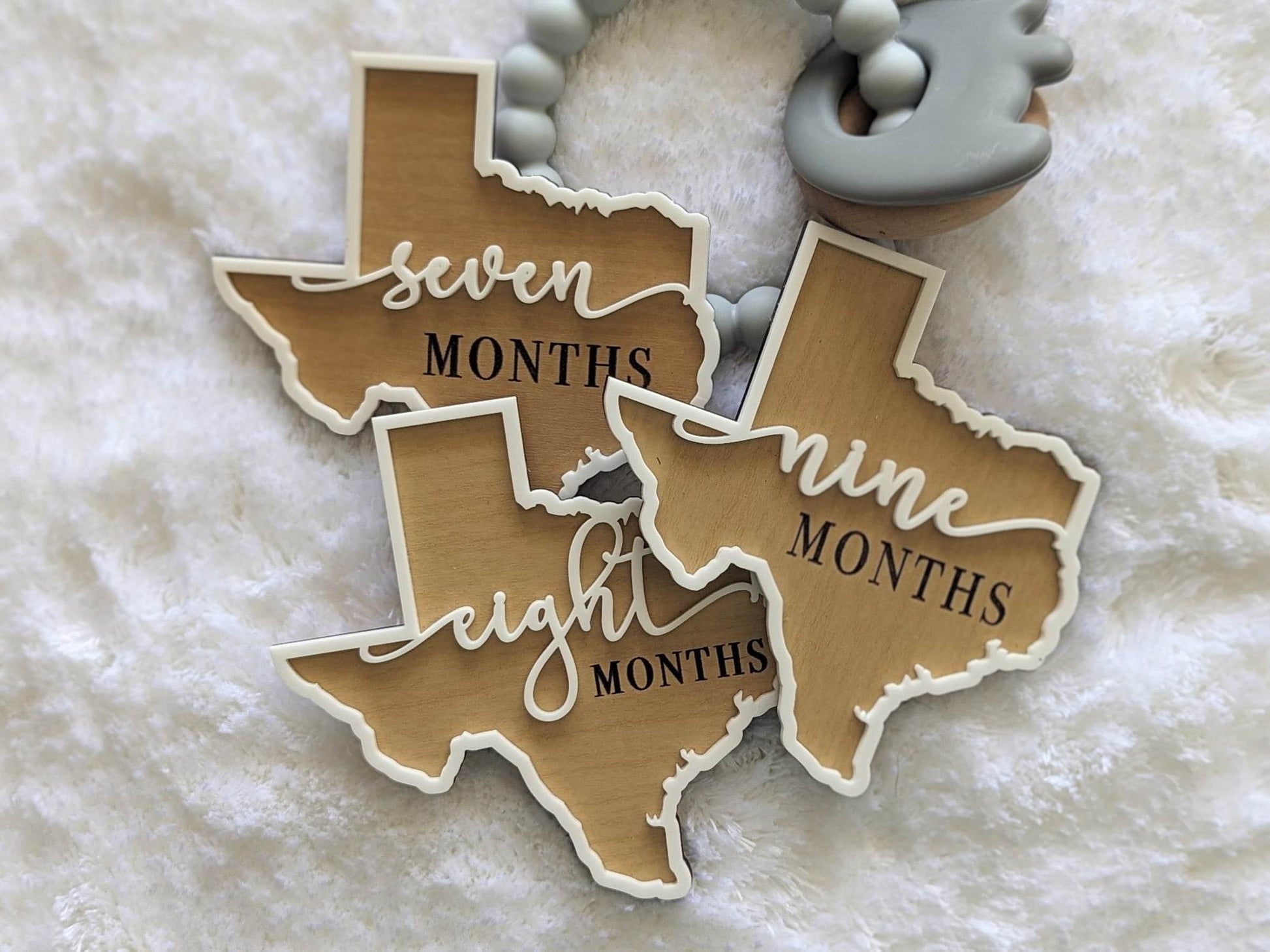 Texas shaped baby milestone props months seven, eight and nine.